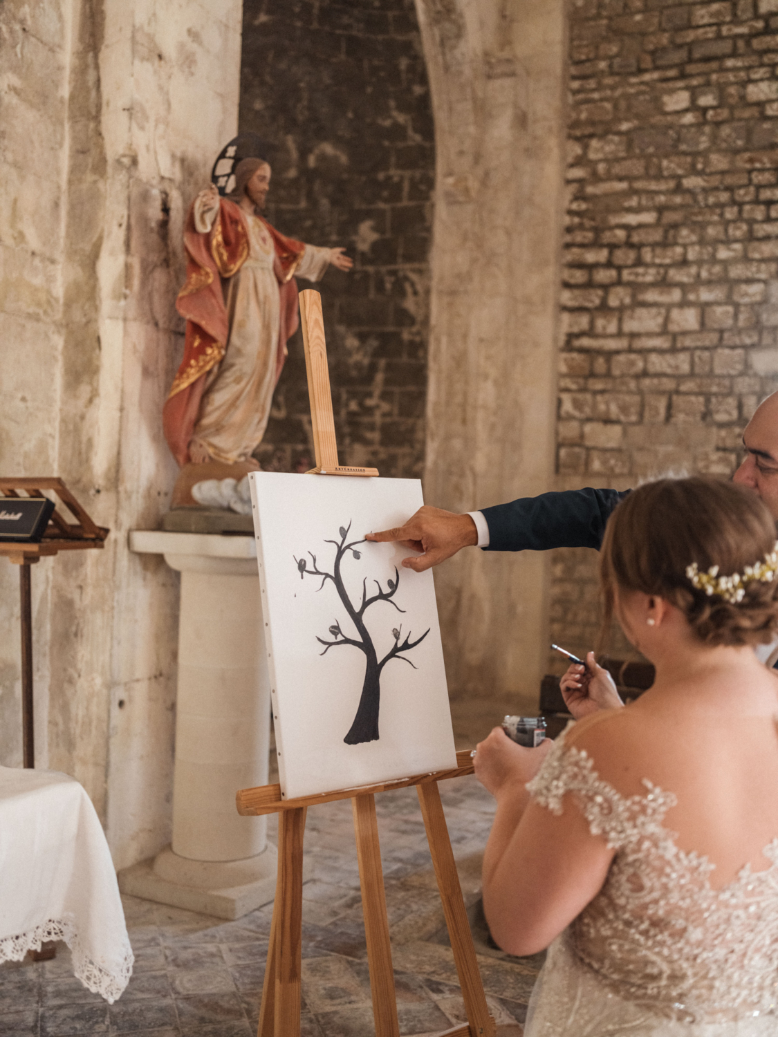 man points at ink painting on wedding day