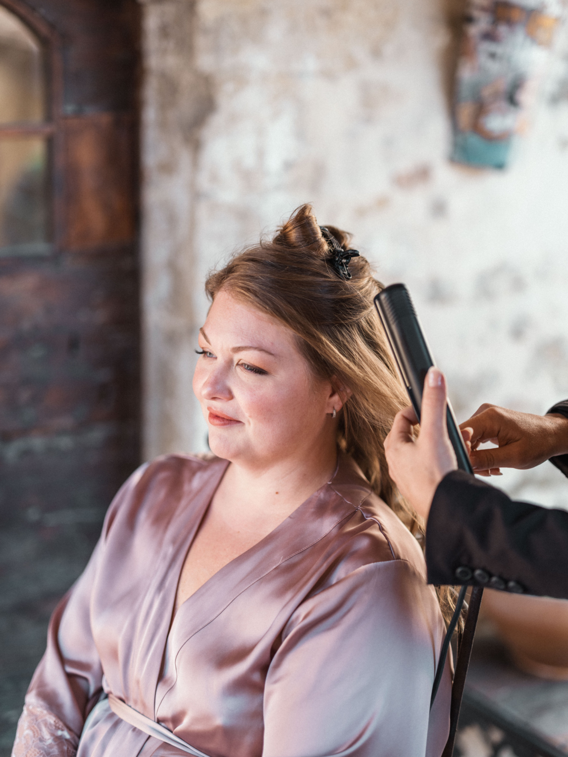 bride gets hair done for wedding