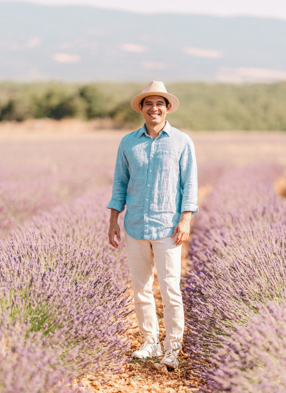 man poses smiling in lavender field