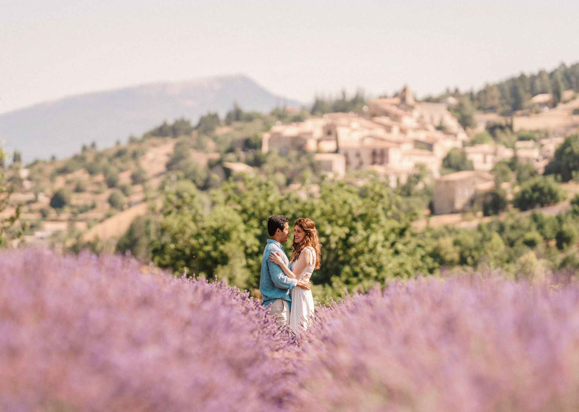 couple smile and embrace in lavender field in provence during Engagement Photos In Provence