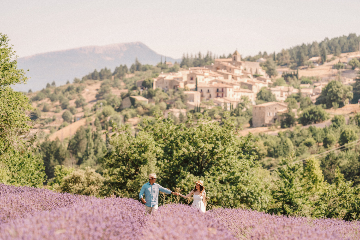 couple walk and smile through lavender field