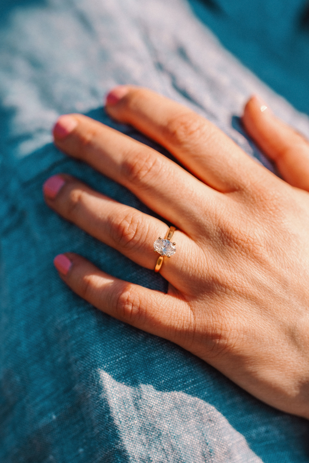 woman wears diamond engagement ring