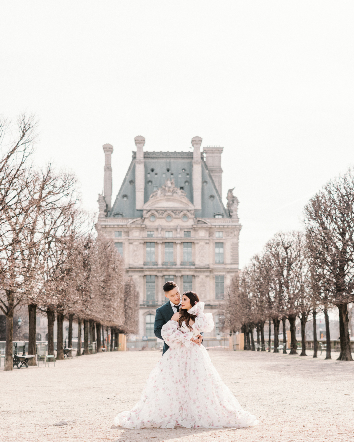 asian couple pose in tuileries gardens in paris france