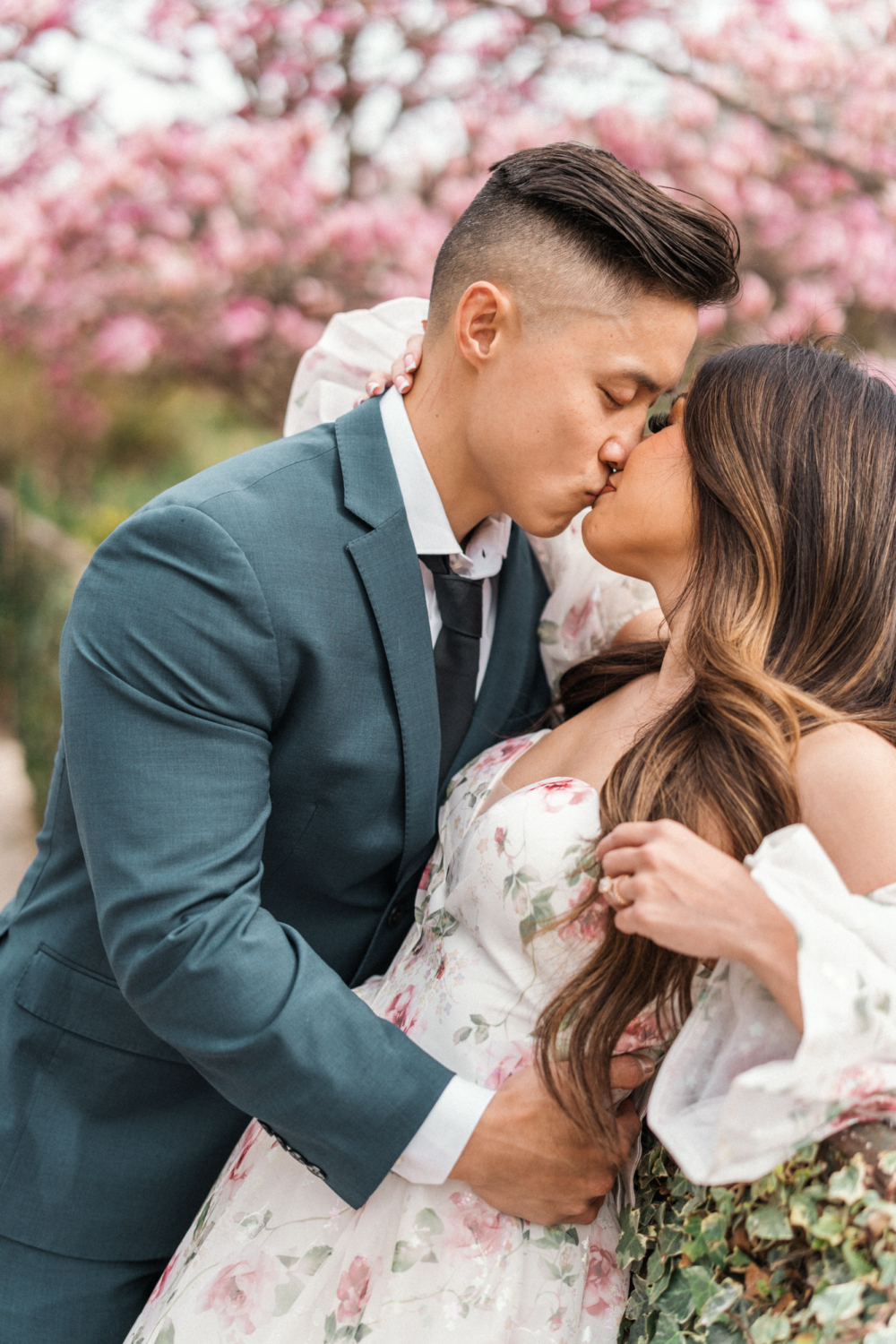 asian couple passionately kiss in paris garden