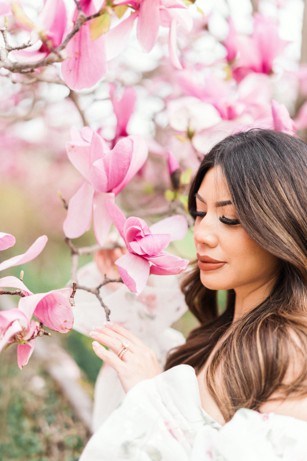 asian woman poses with magnolias in paris france