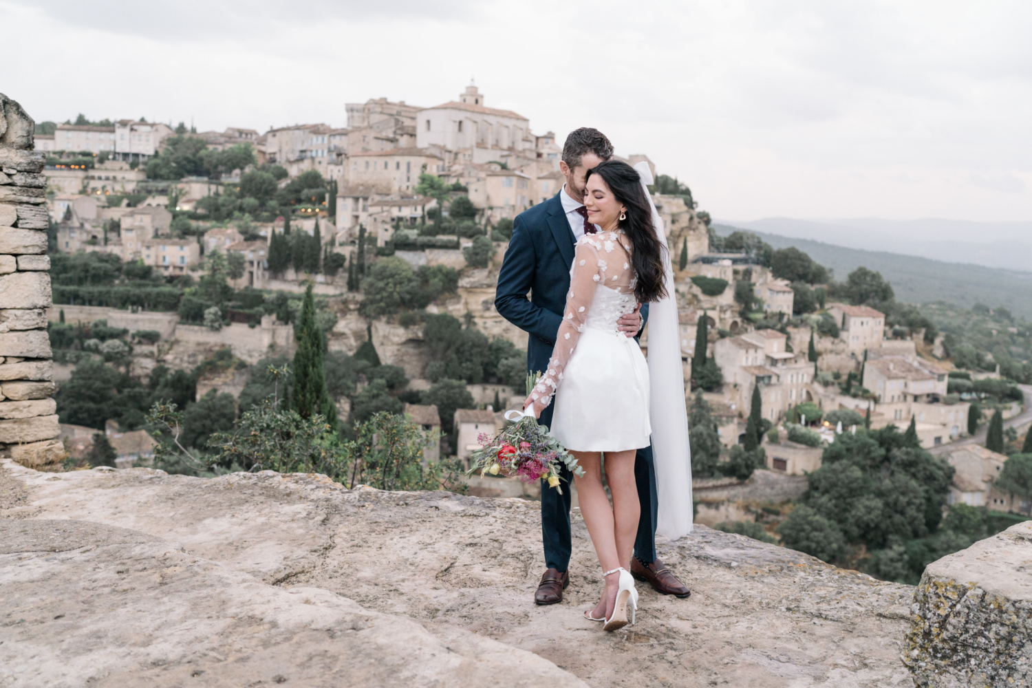 bride and groom pose in gordes france