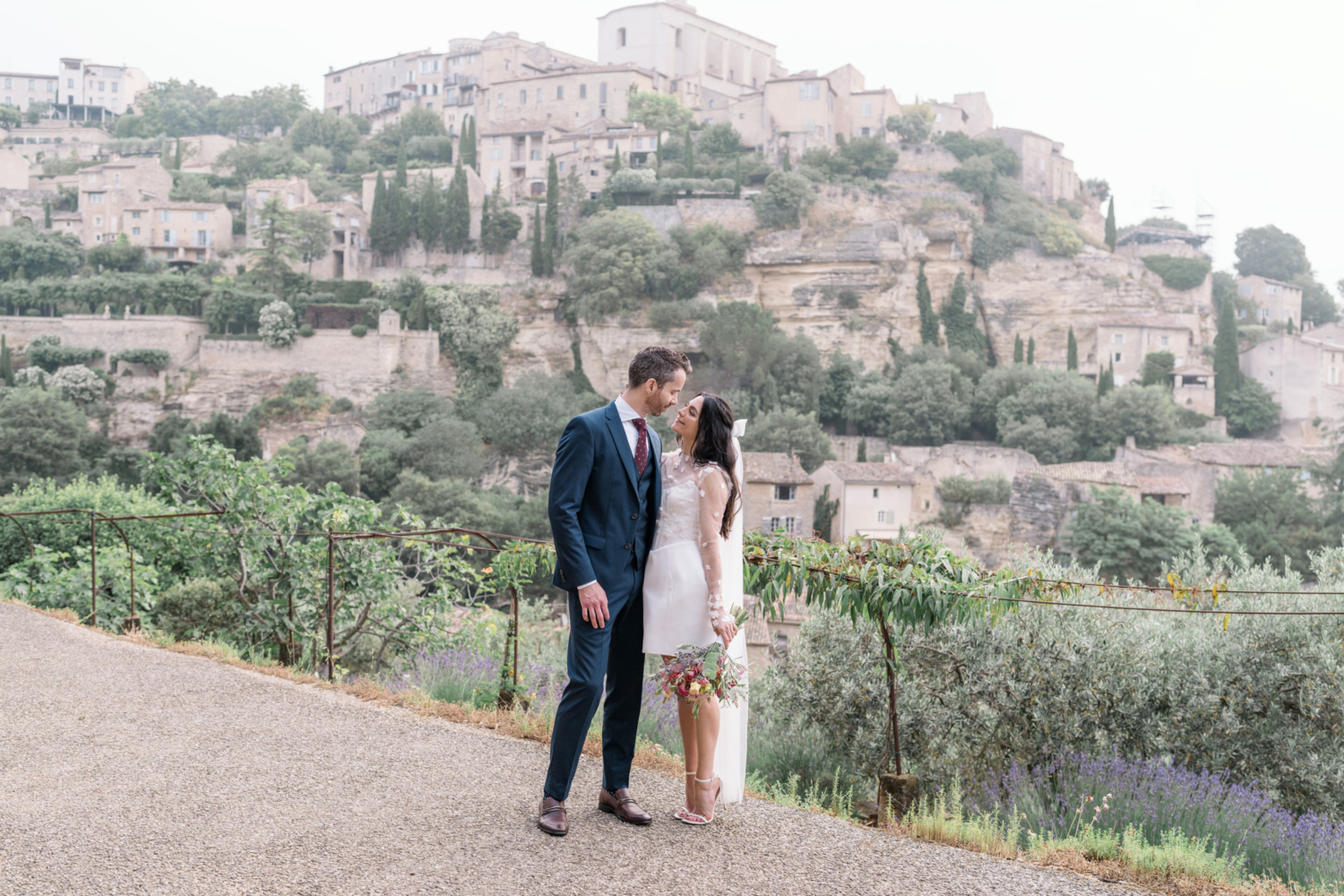 bride and groom smile at each other in gordes france