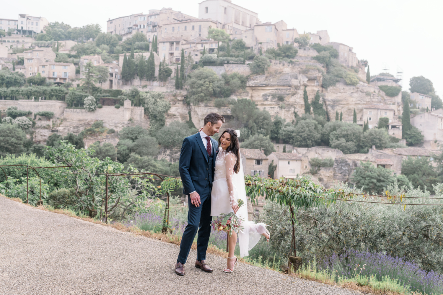 bride kicks up heel on her wedding day in gordes france