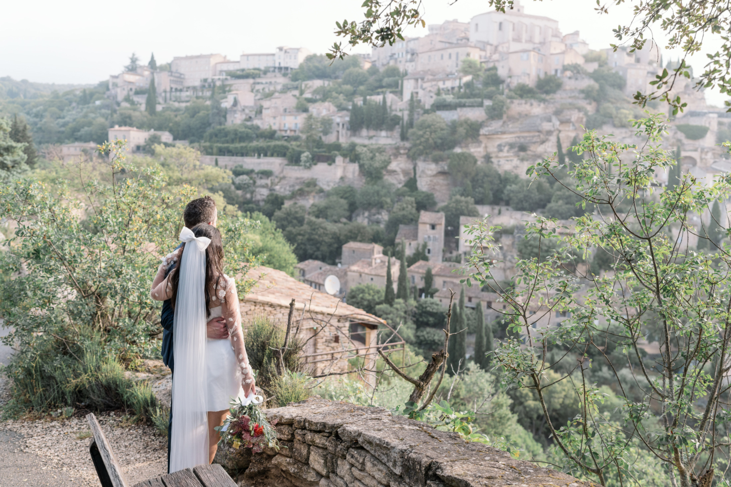 bride and groom look at the village of gordes france