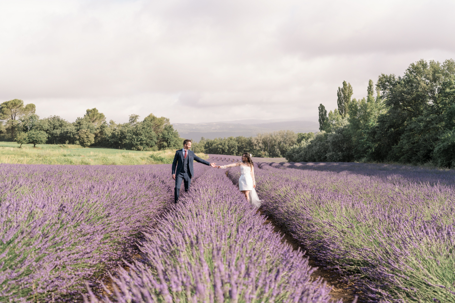 bride and groom pose in lavender field in provence