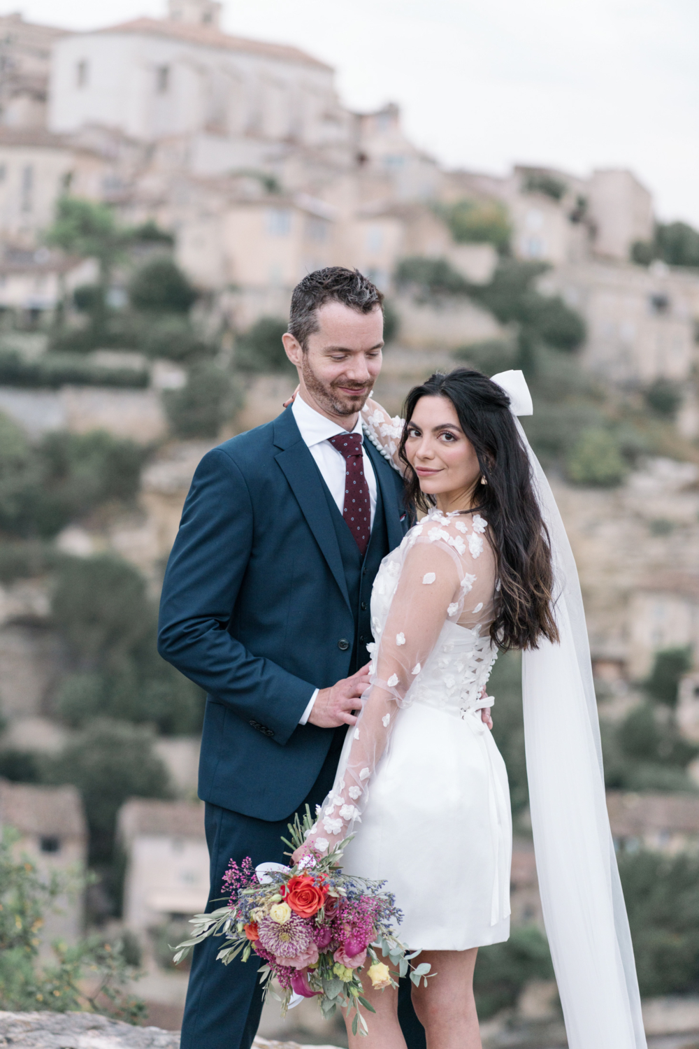 bride and groom pose in gordes france