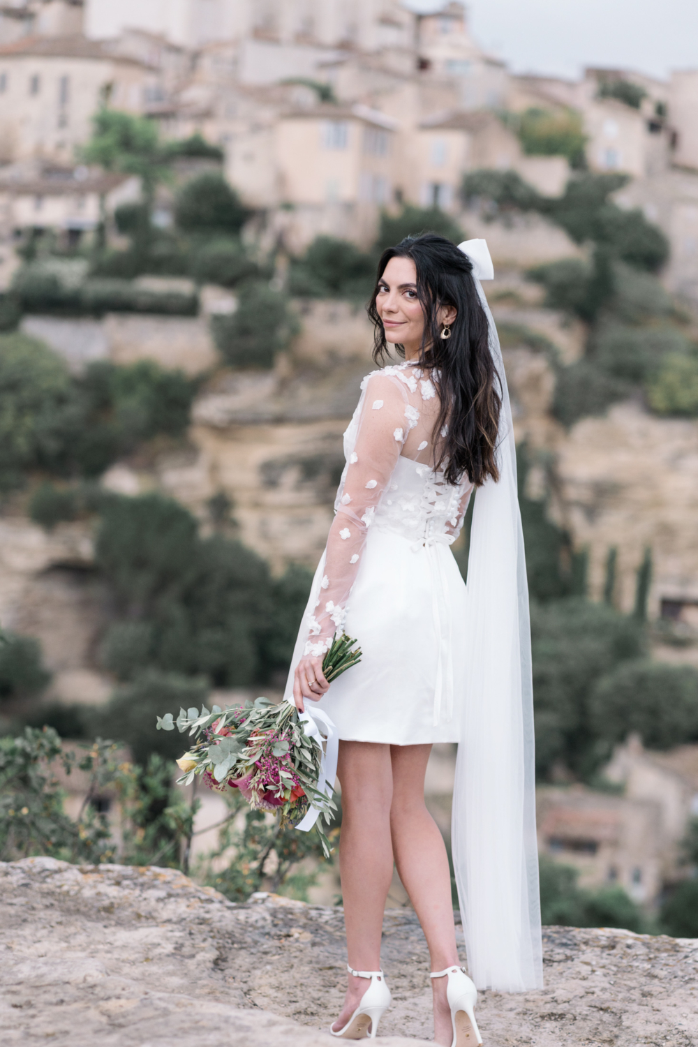 beautiful bride poses with bouquet in gordes france