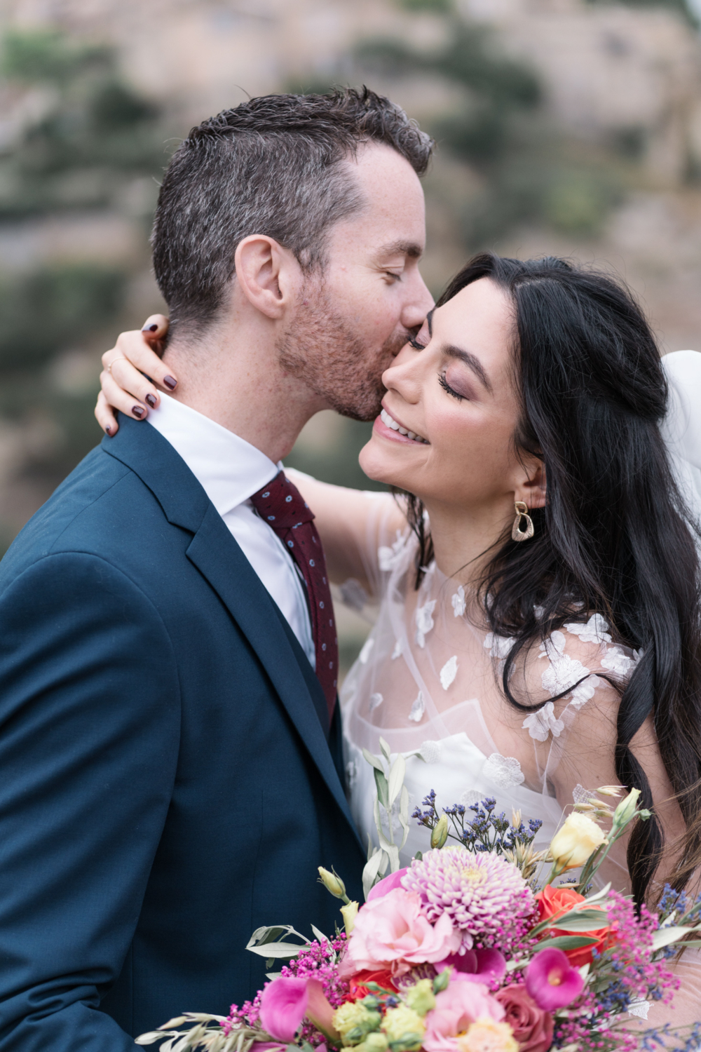 groom kisses bride on cheek on their wedding day in gordes france