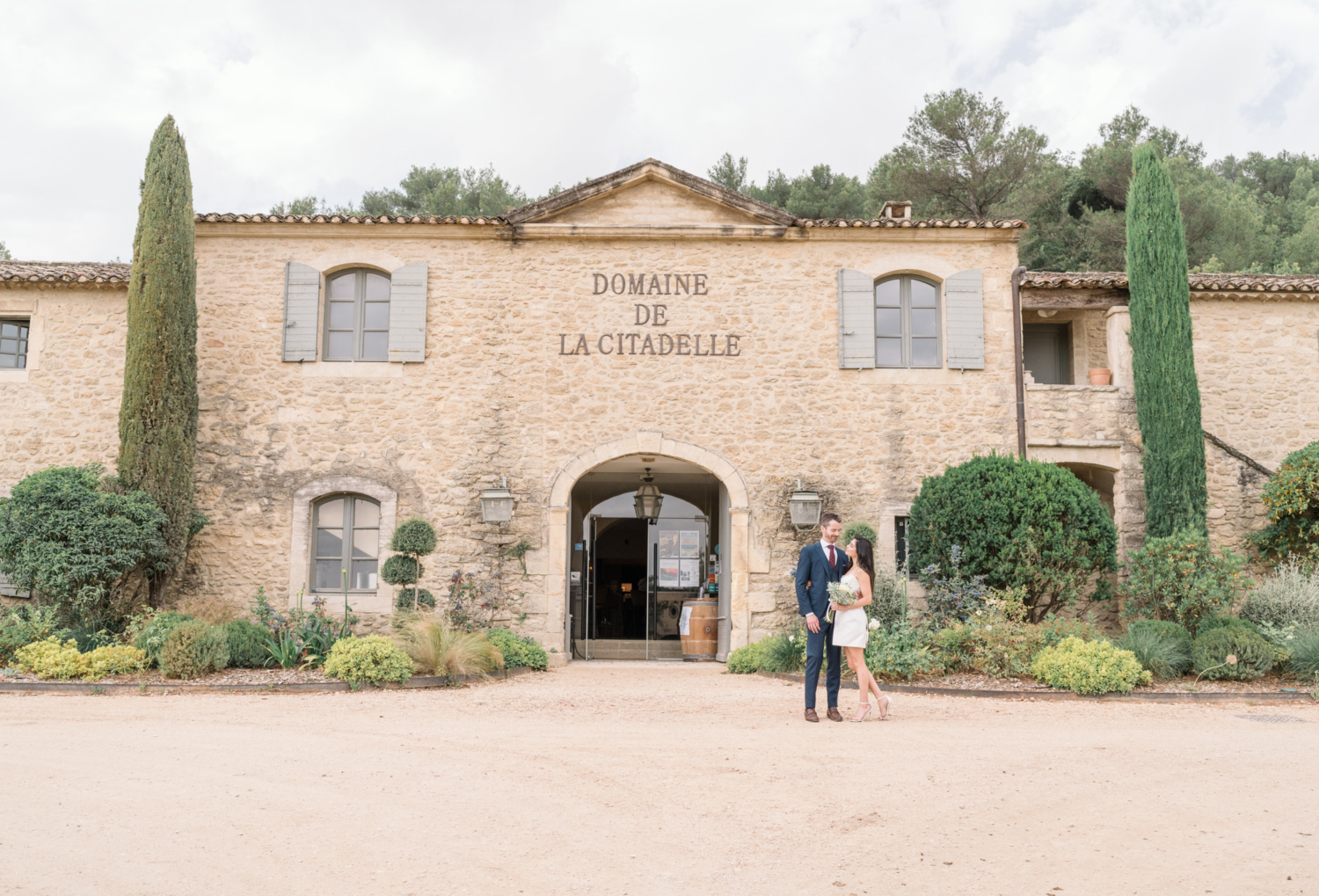 bride and groom pose for their wedding ceremony at the domaine de la citadelle in menerbes france