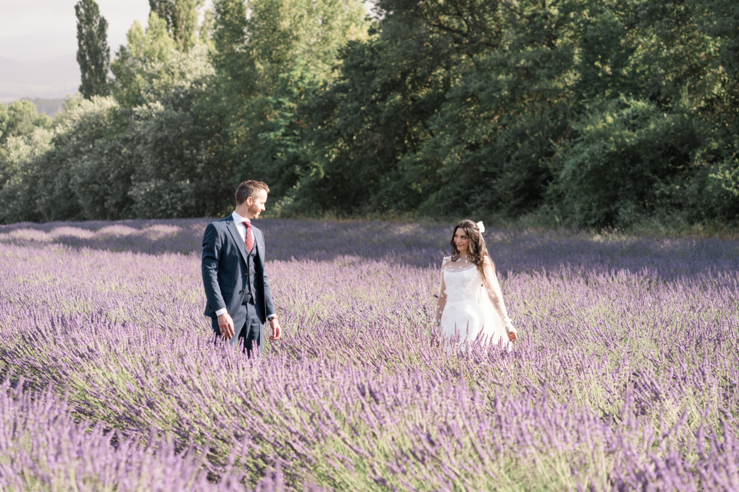 bride and groom pose in a lavender field in provence