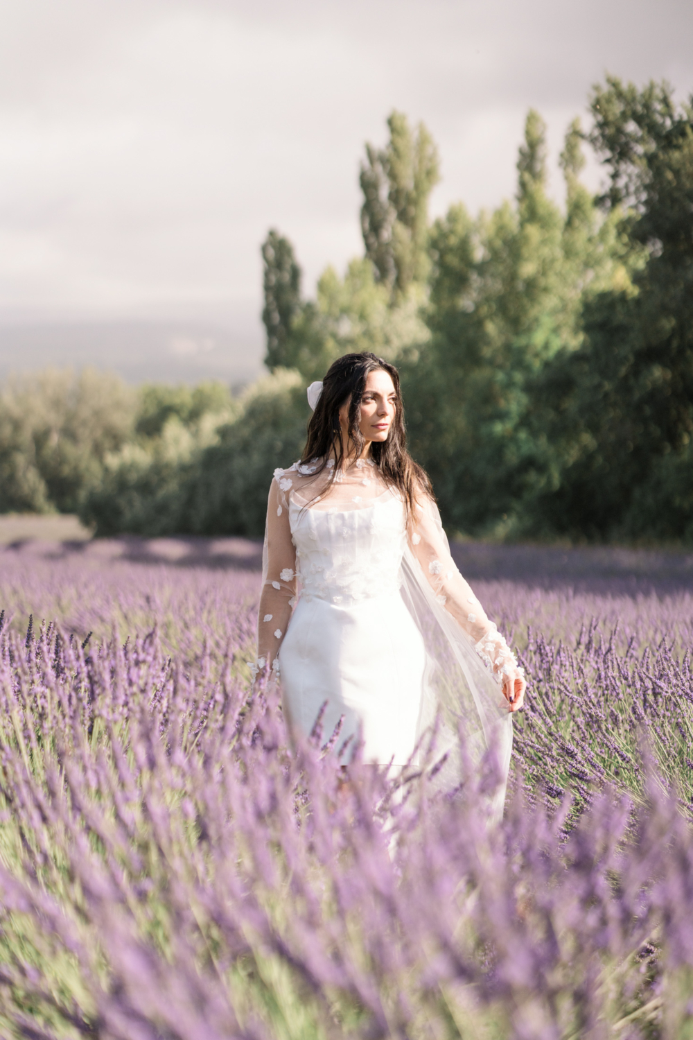 bride poses with her veil in a lavender field in provence