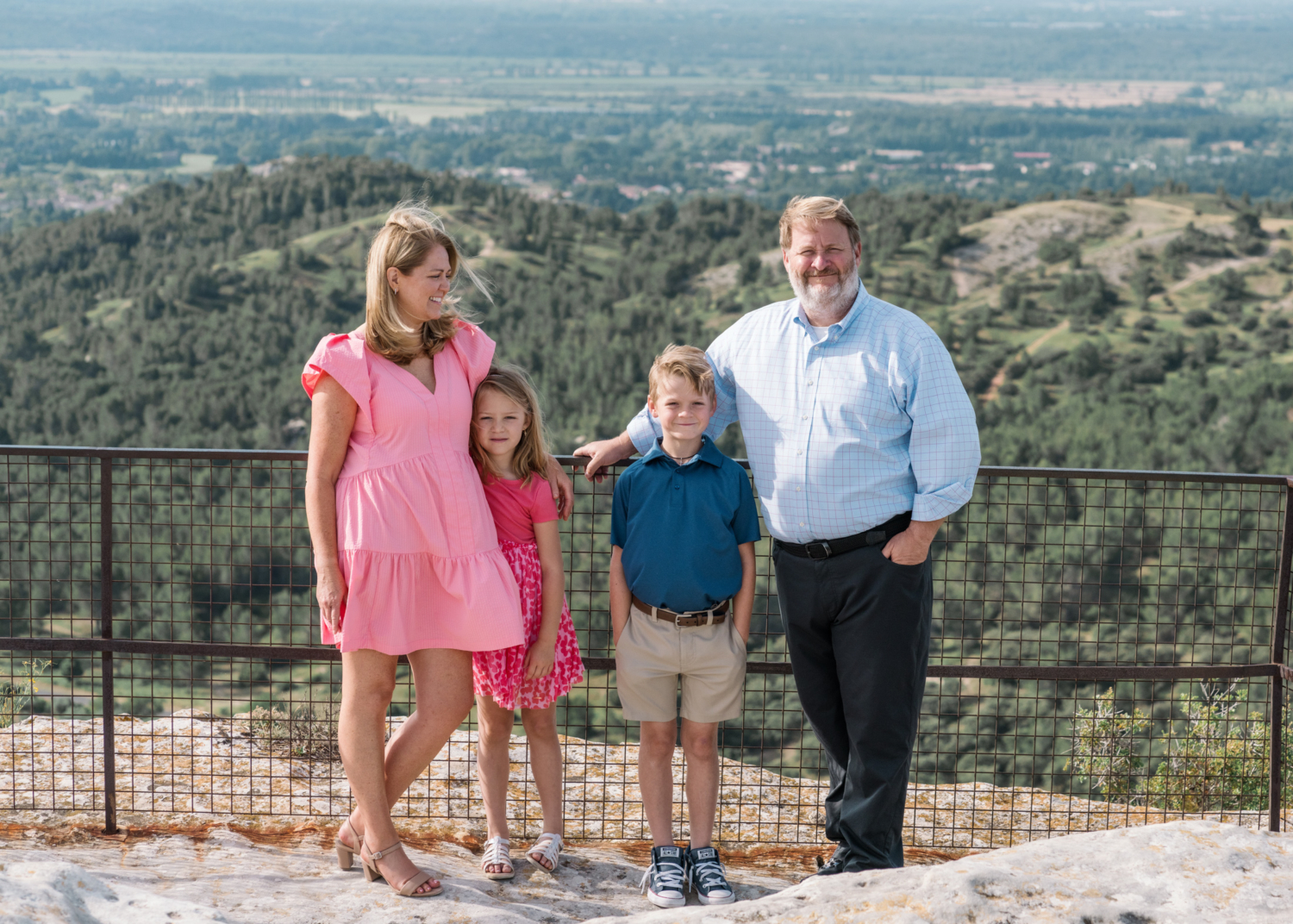 cute family poses in front of amazing view les baux de provence france