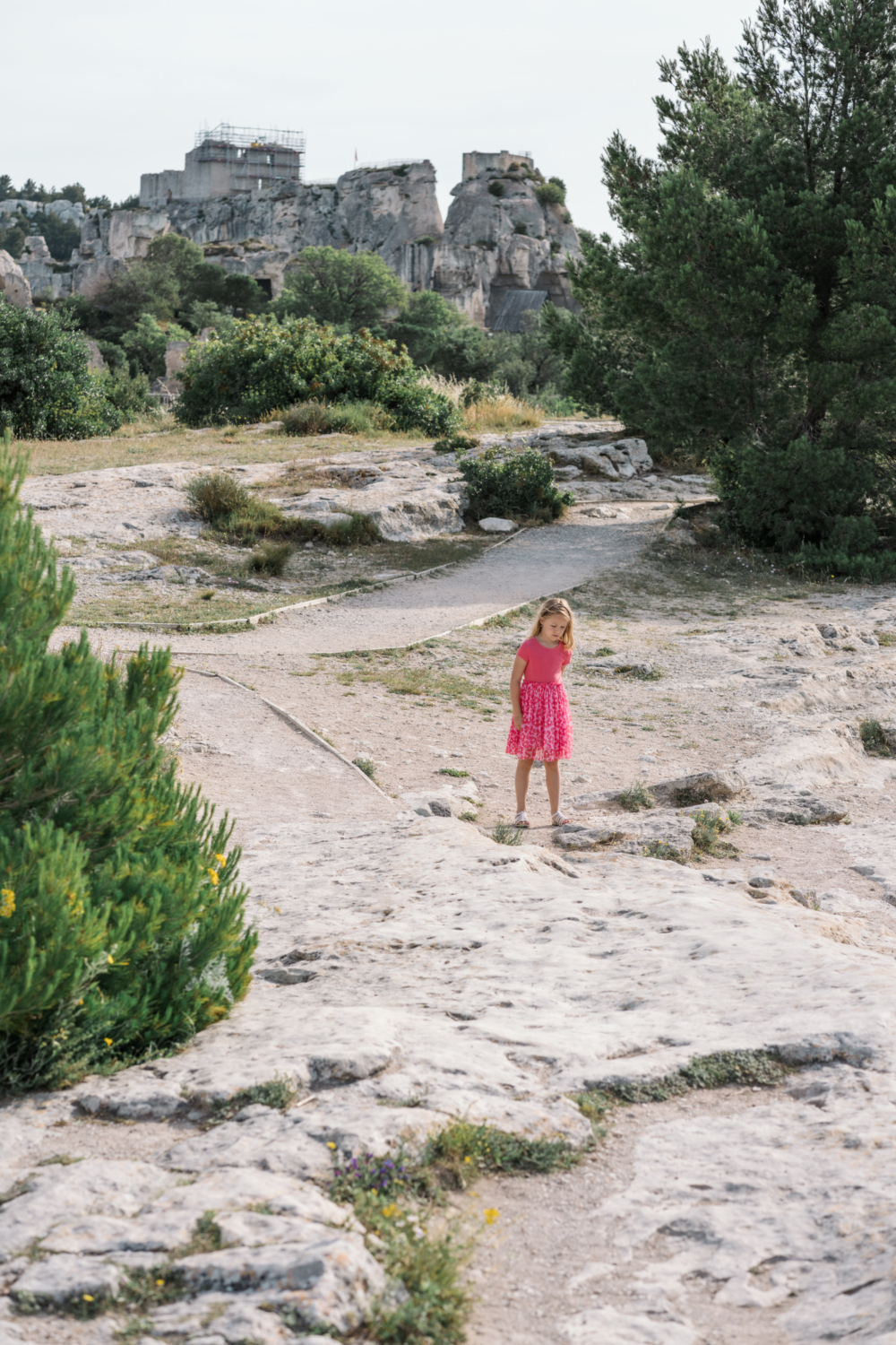 little girl walks on the rocks in les baux de provence france