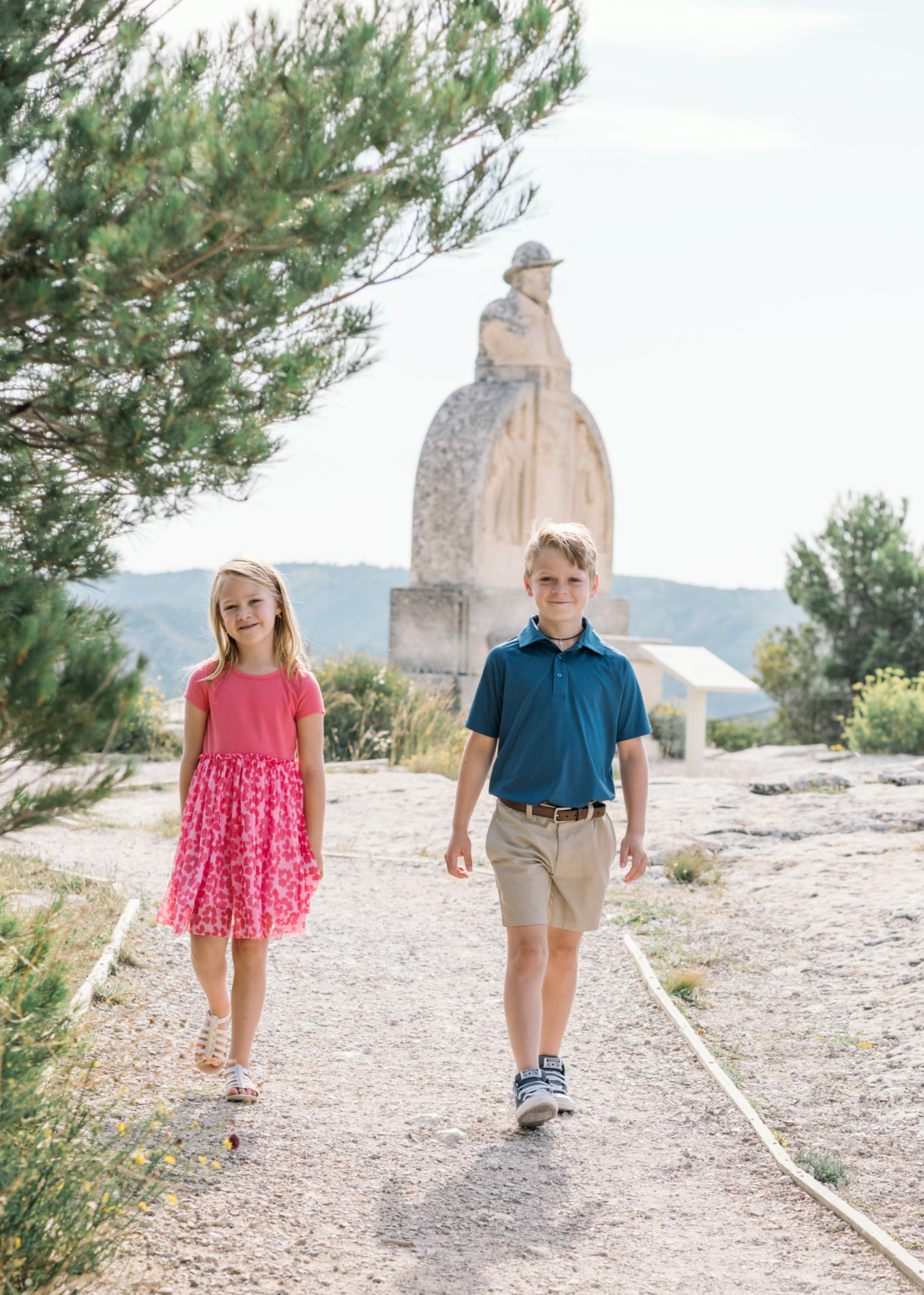 cute young brother and sister walk in les baux de provence france