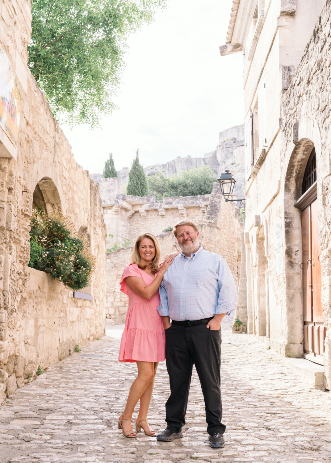 husband and wife pose in historic les baux de provence