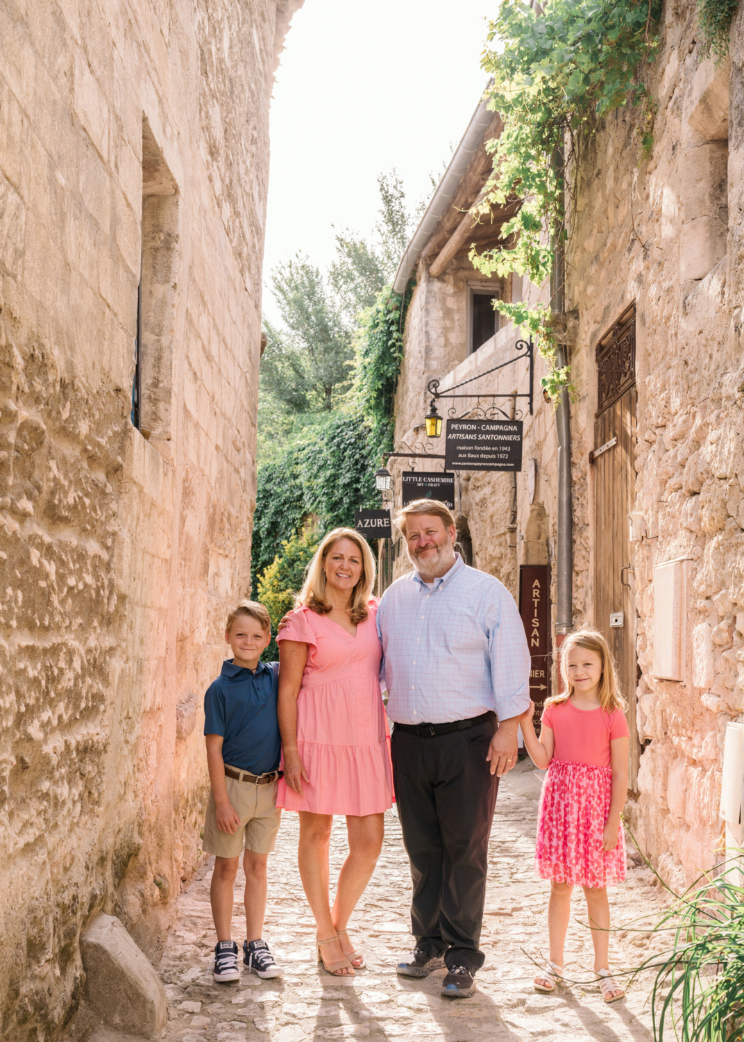 cute young family of four have fun in les baux de provence france