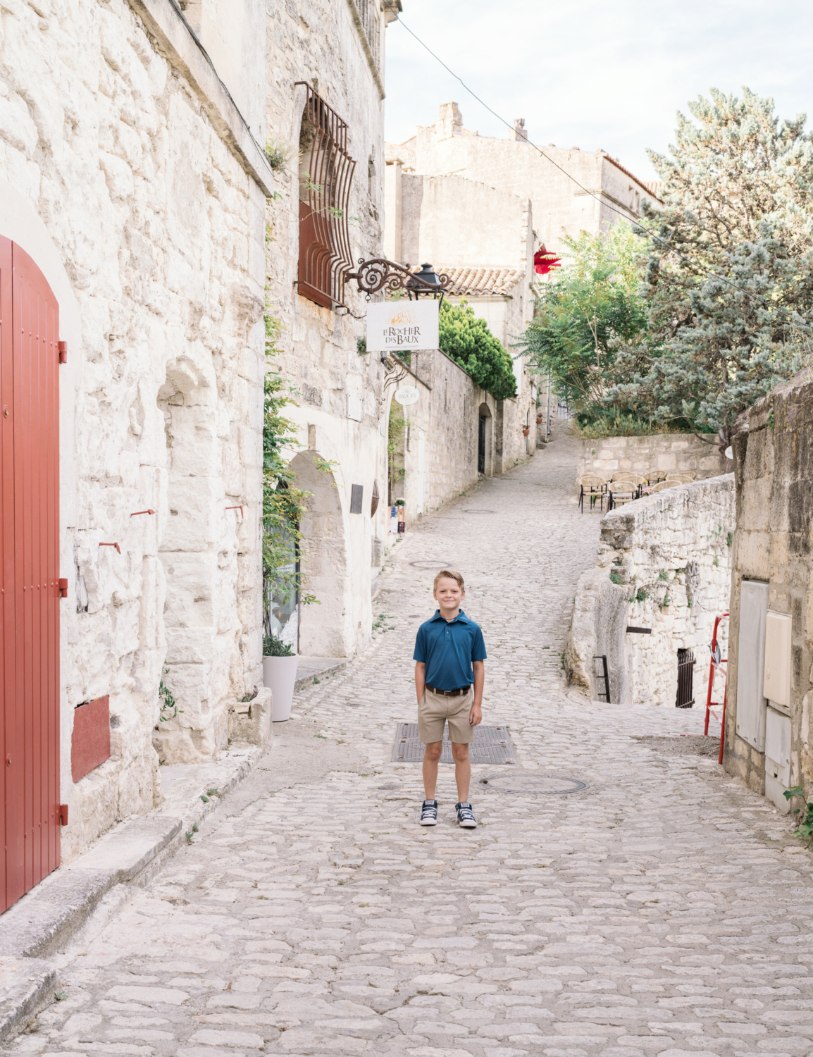 young boy walks the medieval city of les baux de provence france