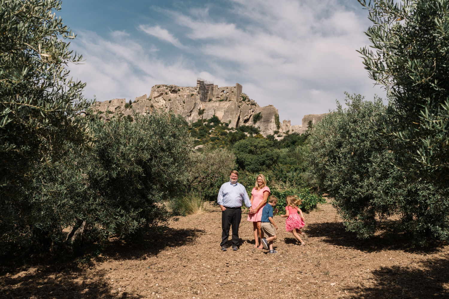 boy chases girl around parents in les baux de provence france