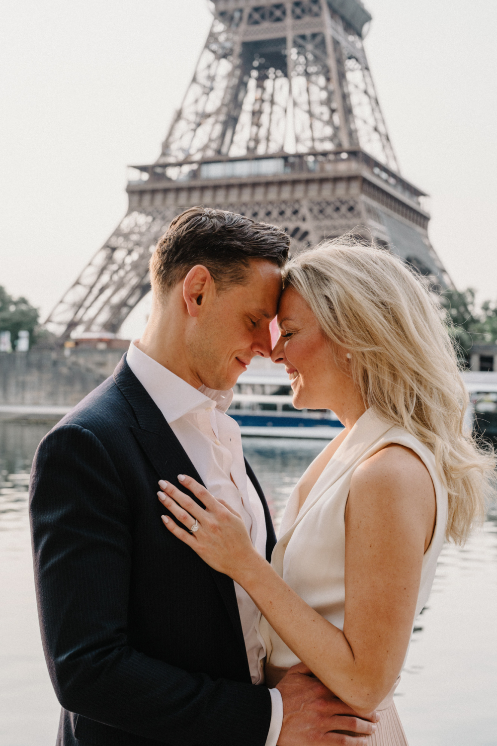 engaged couple laughter with eiffel tower view in paris