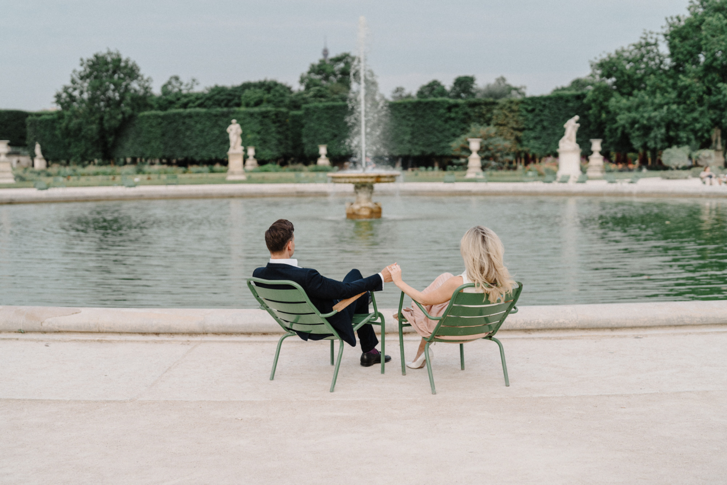 engaged couple hold hands in tuileries gardens in paris
