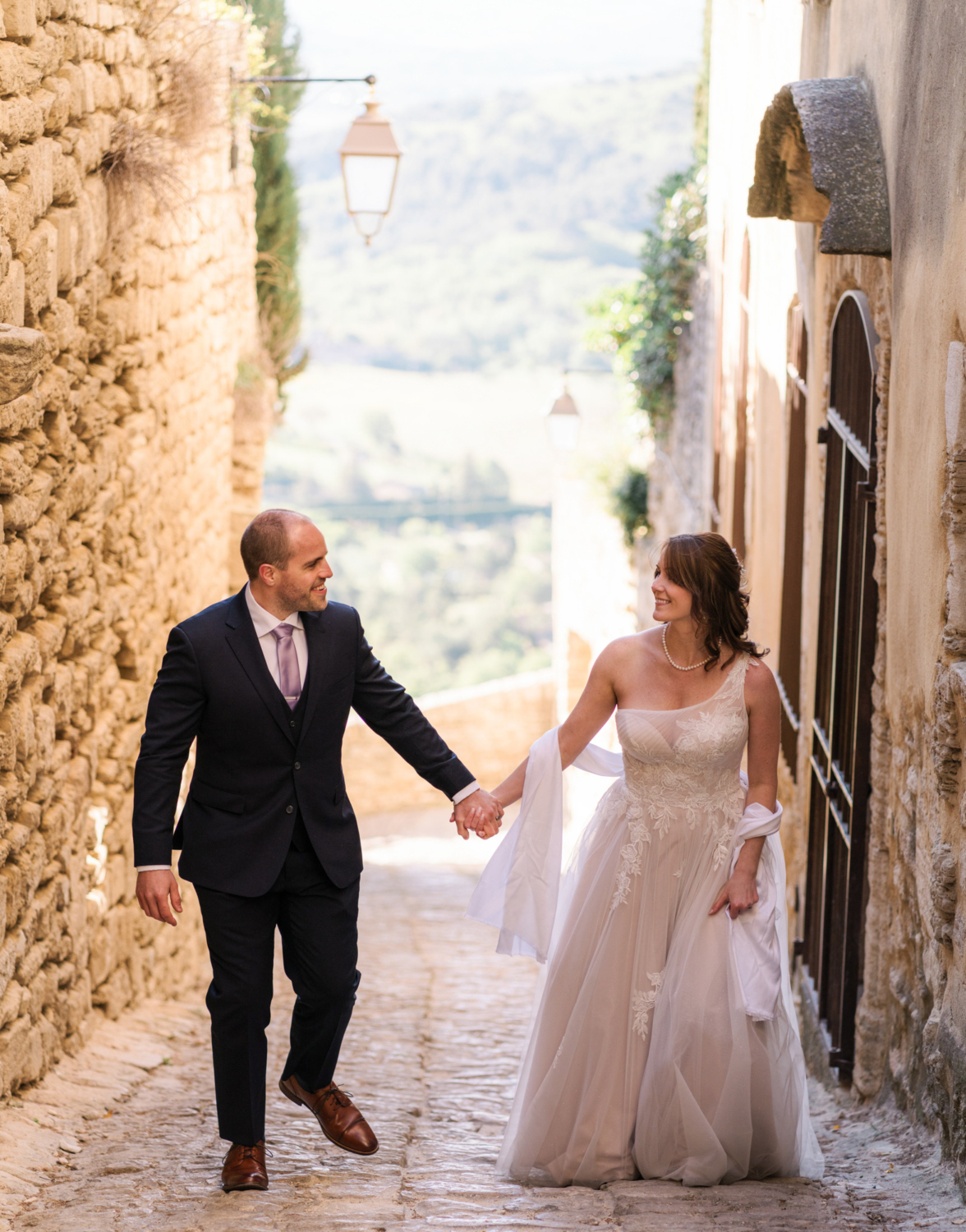 bride and groom smiling and walking in gordes france