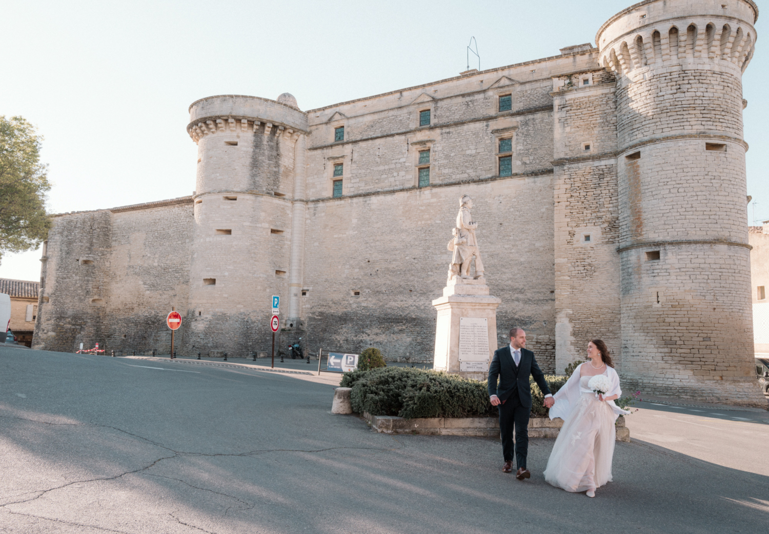 newlywed couple laughing with castle in background