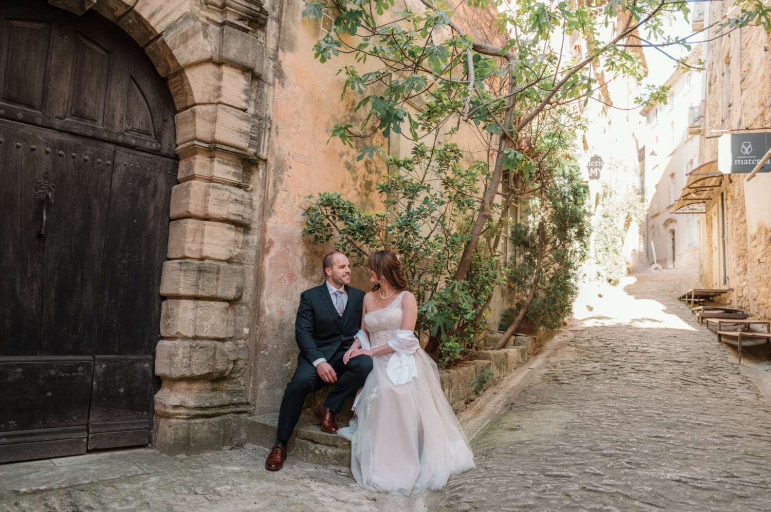 newly married couple sitting on bench in gordes france