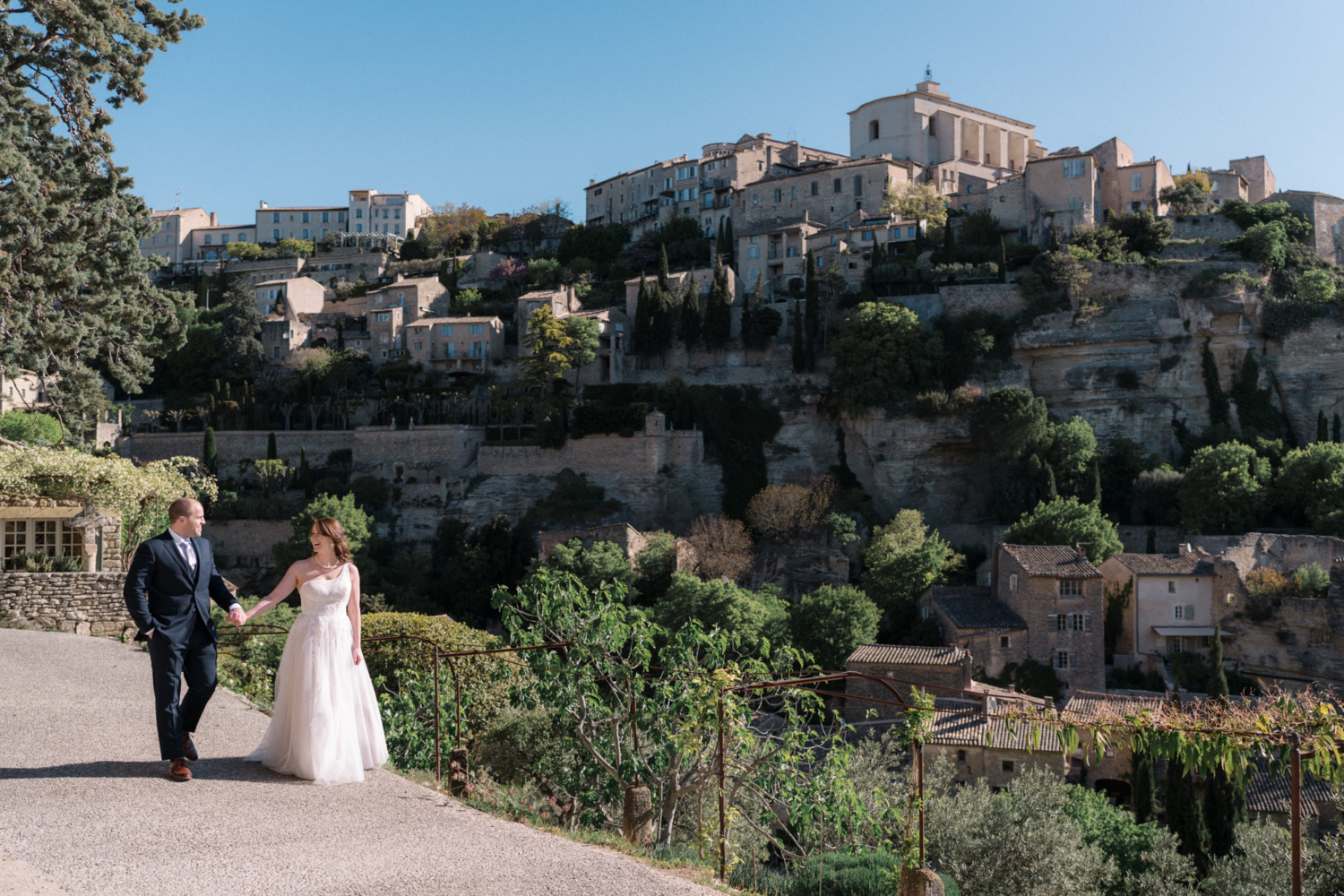 newlywed couple walking in gordes after their wedding
