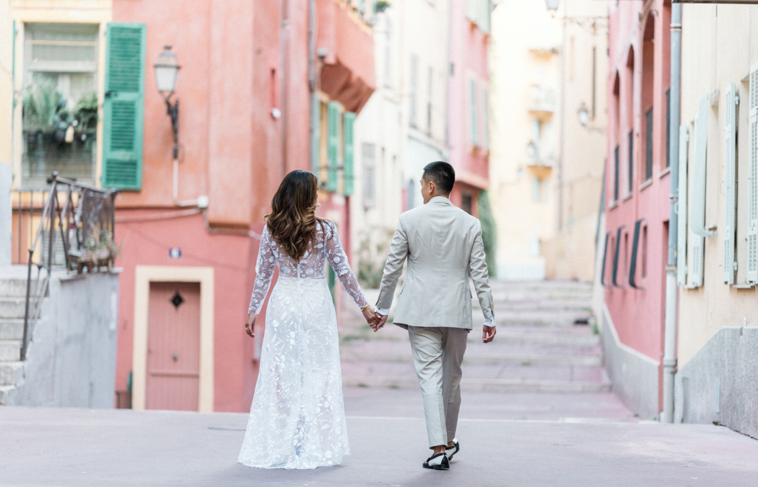 man and woman walk hand in hand into the city in nice france