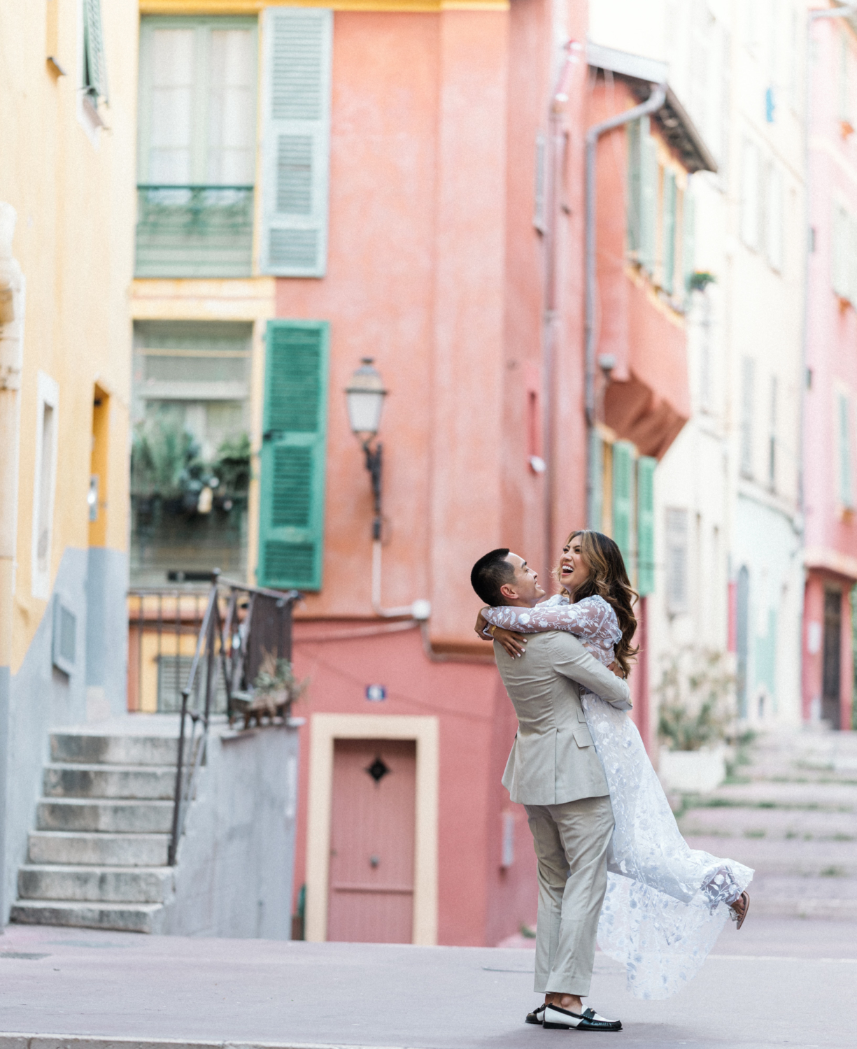 man twirls woman while she laughs in nice france