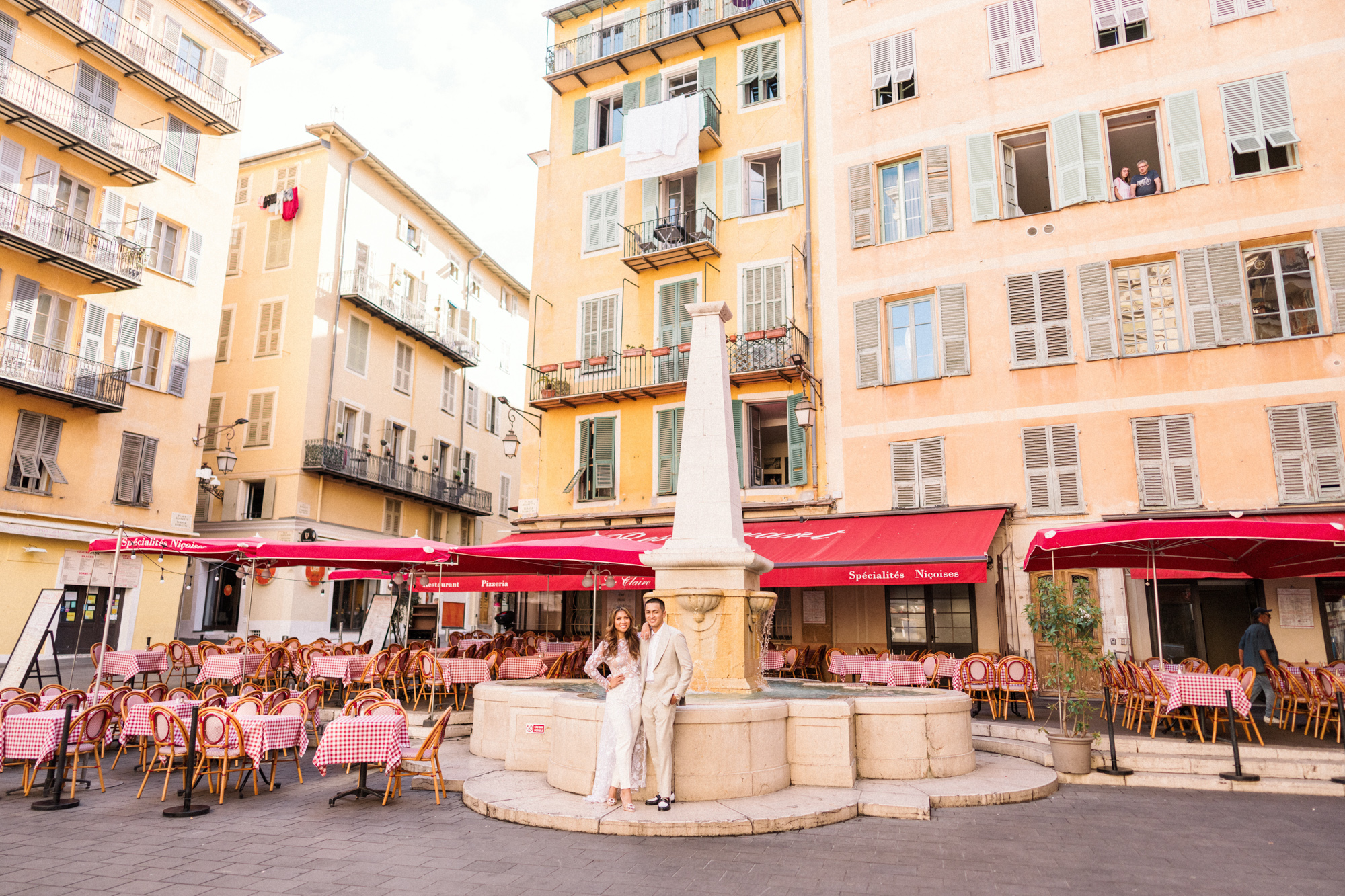 cute couple pose in front of italian restaurant in nice france