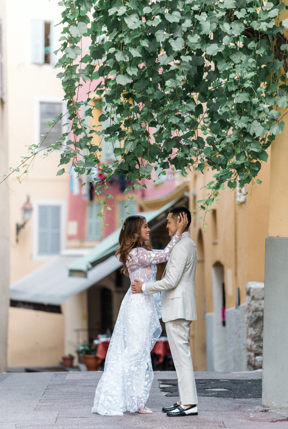 woman holds man's head and smiles in nice france