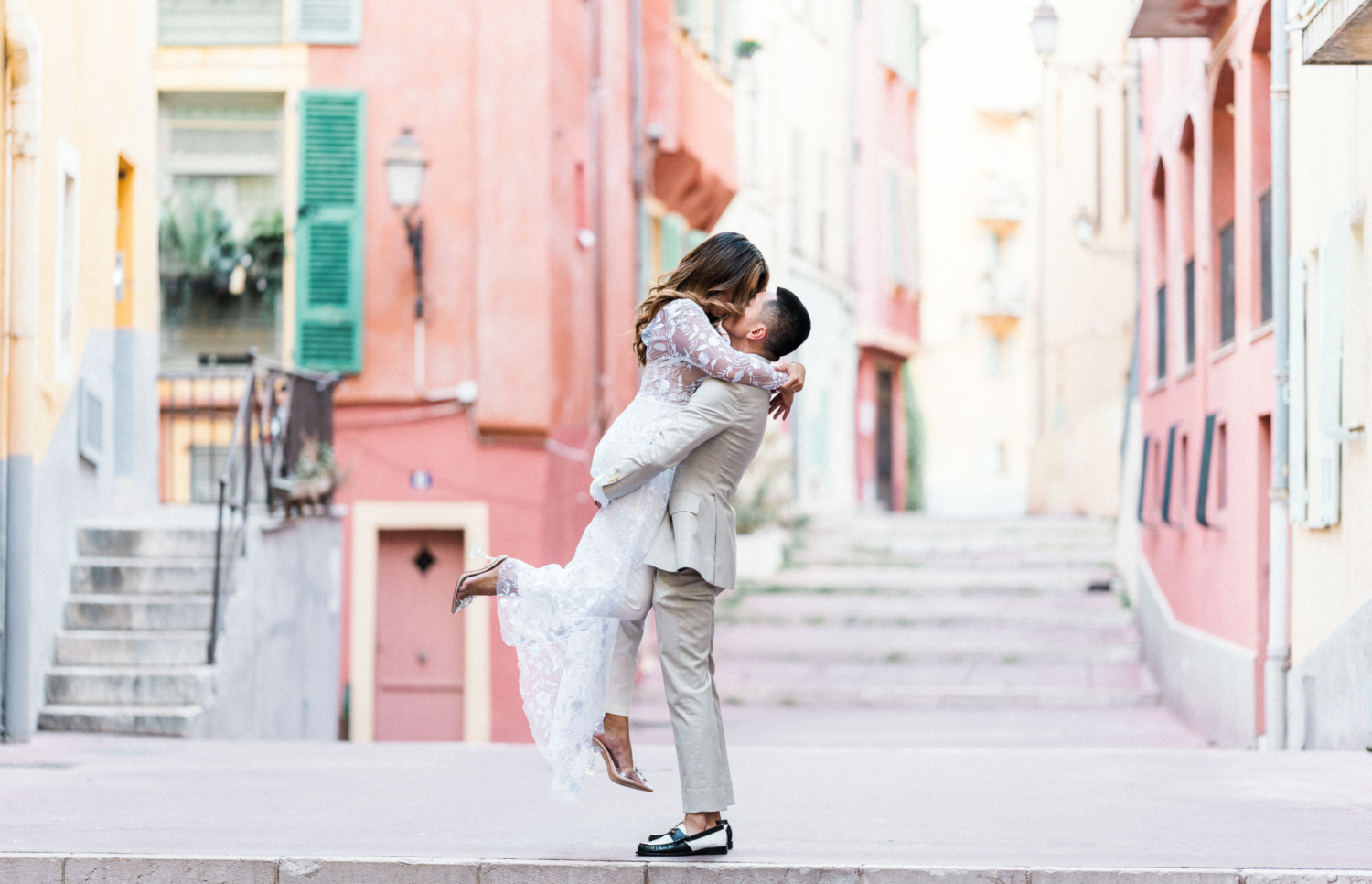 man lifts woman in the air in old town nice france