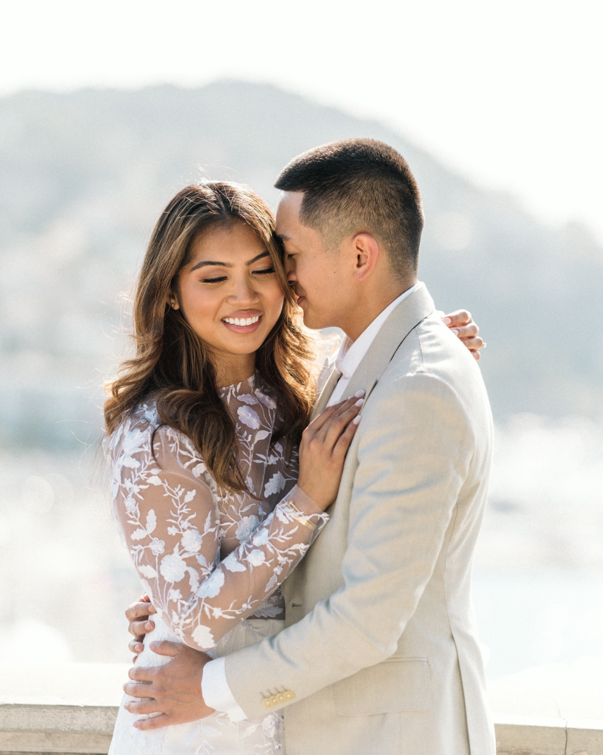 beautiful engaged couple embrace next to sea in nice france