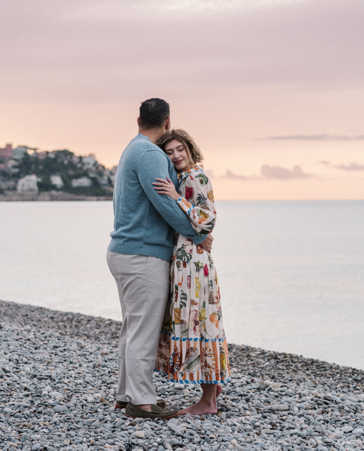 woman and man hold each other on beach in nice france