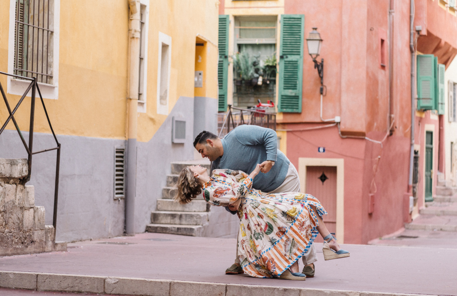 man and woman dance among colorful buildings in nice france