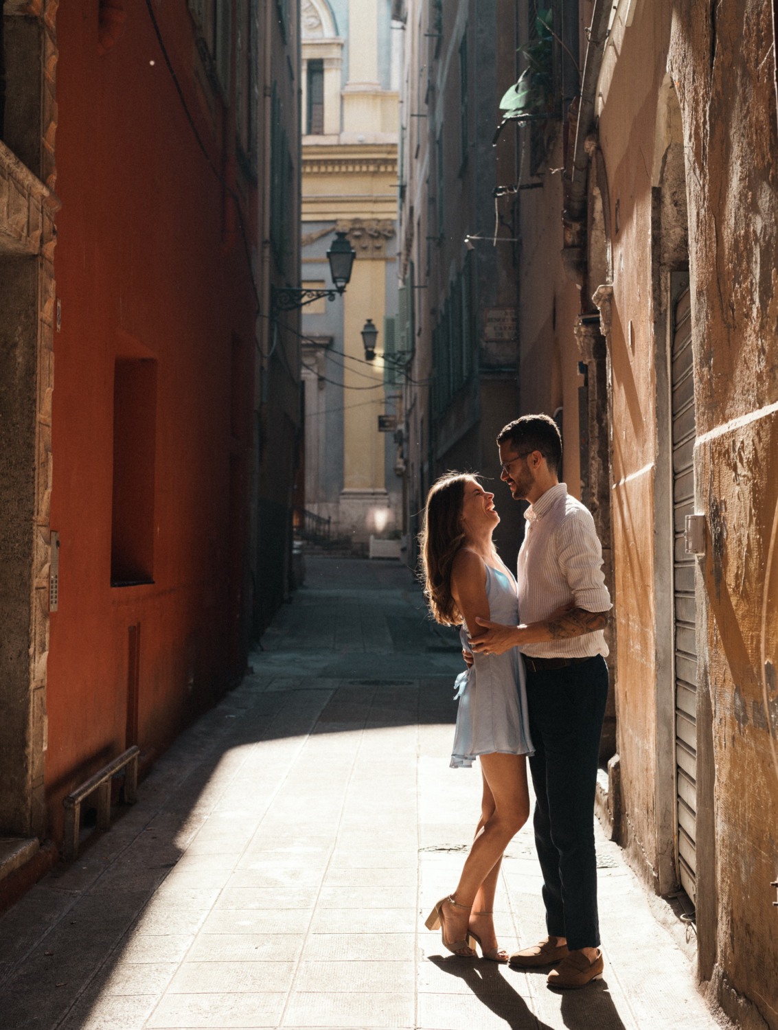 cute couple laugh together in old town nice