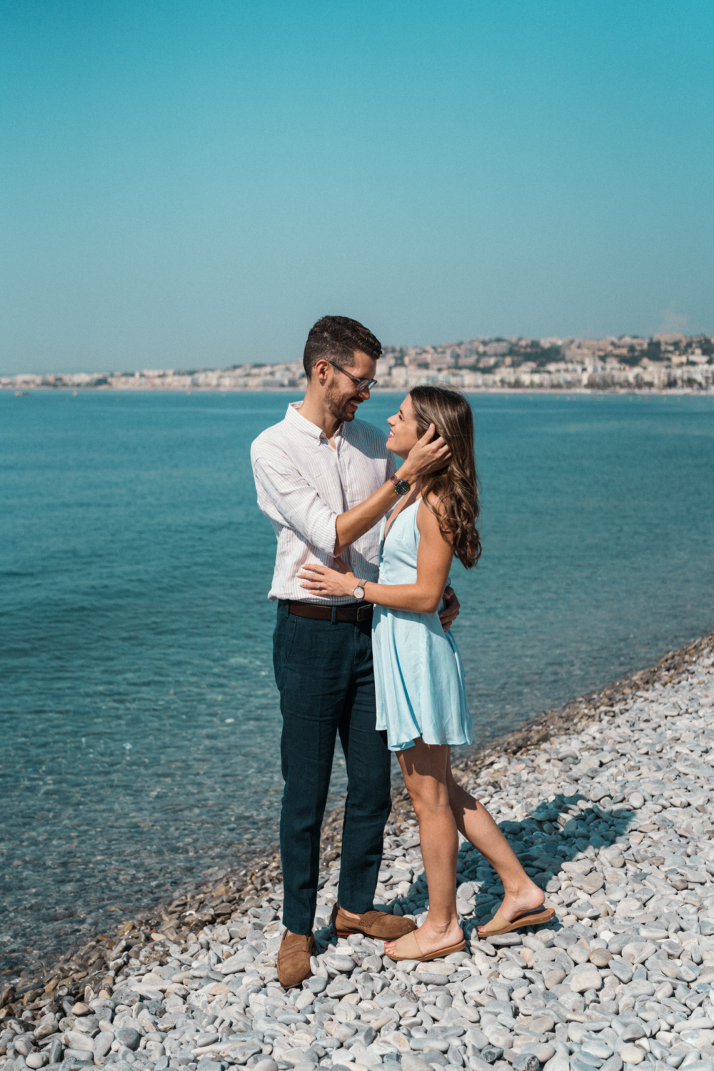 newlywed couple embrace on beach in nice france