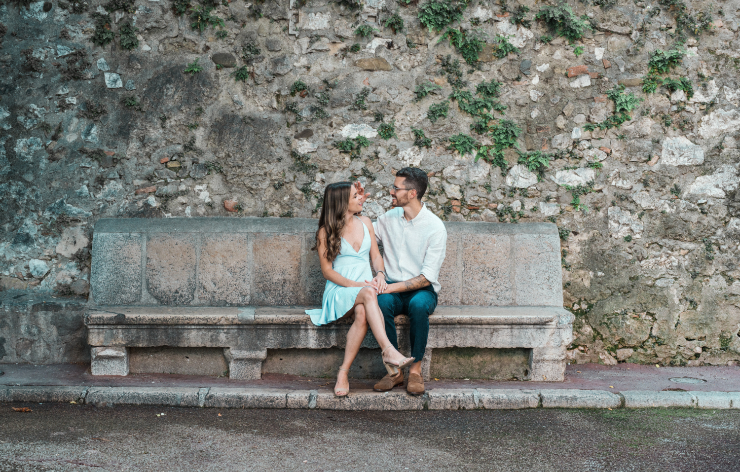 couple sit together on bench in nice france