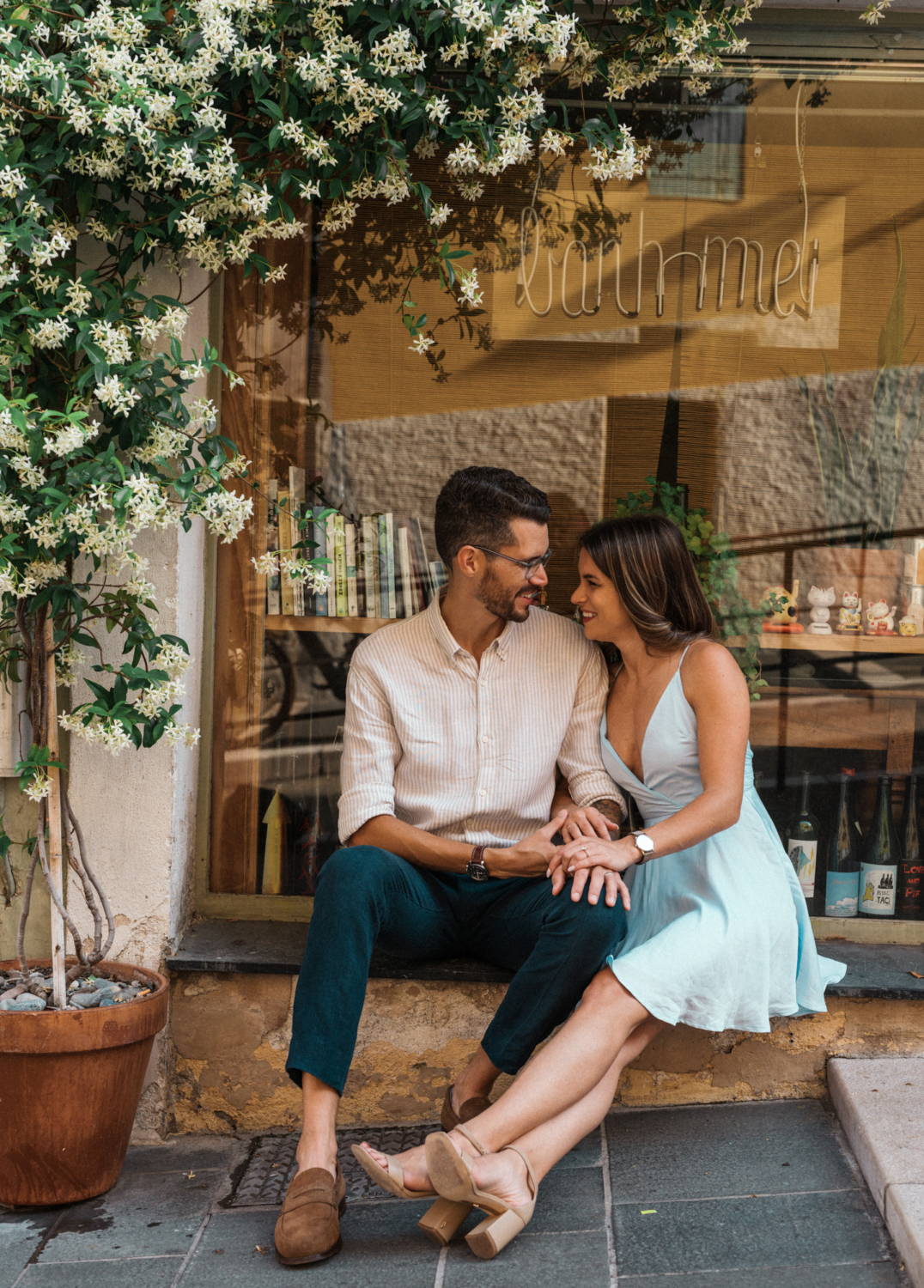 cute couple laugh next to jasmine plant in nice france