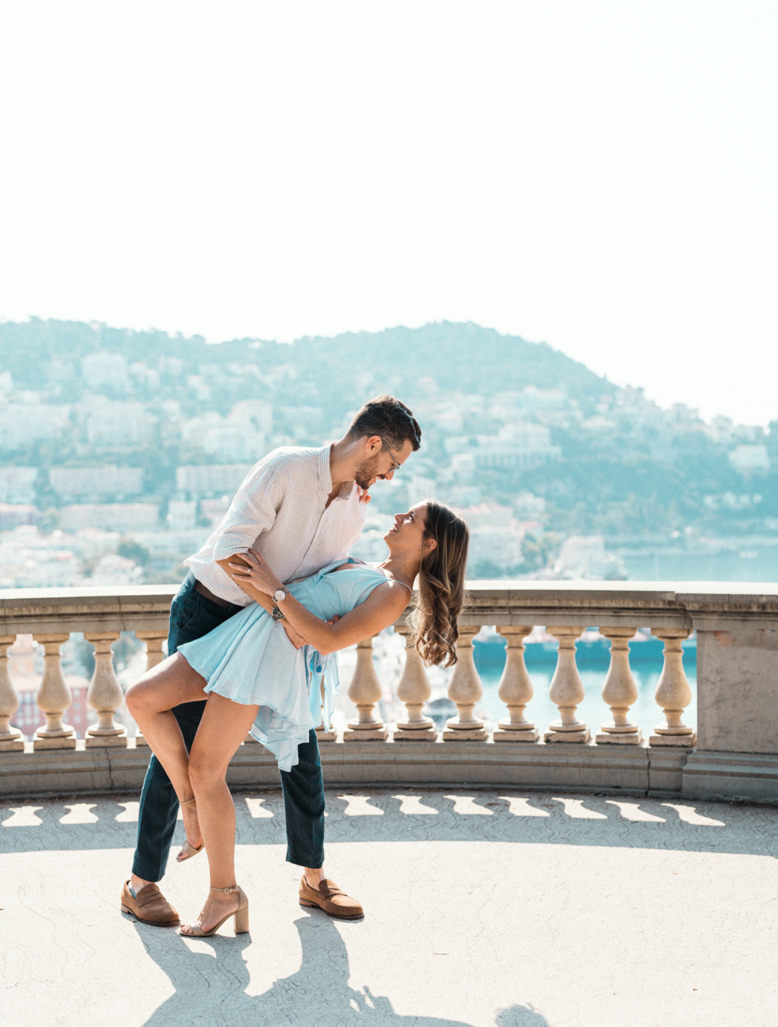 man dips woman with view of marina in nice france