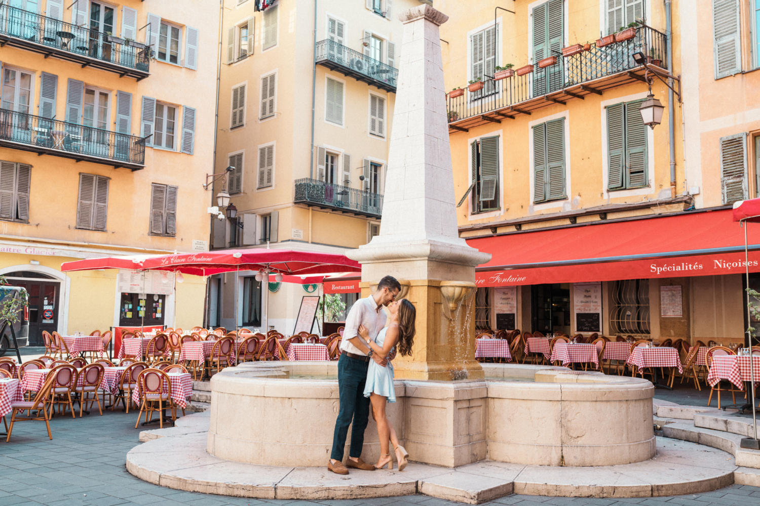 newlywed couple kiss in front of italian restaurant