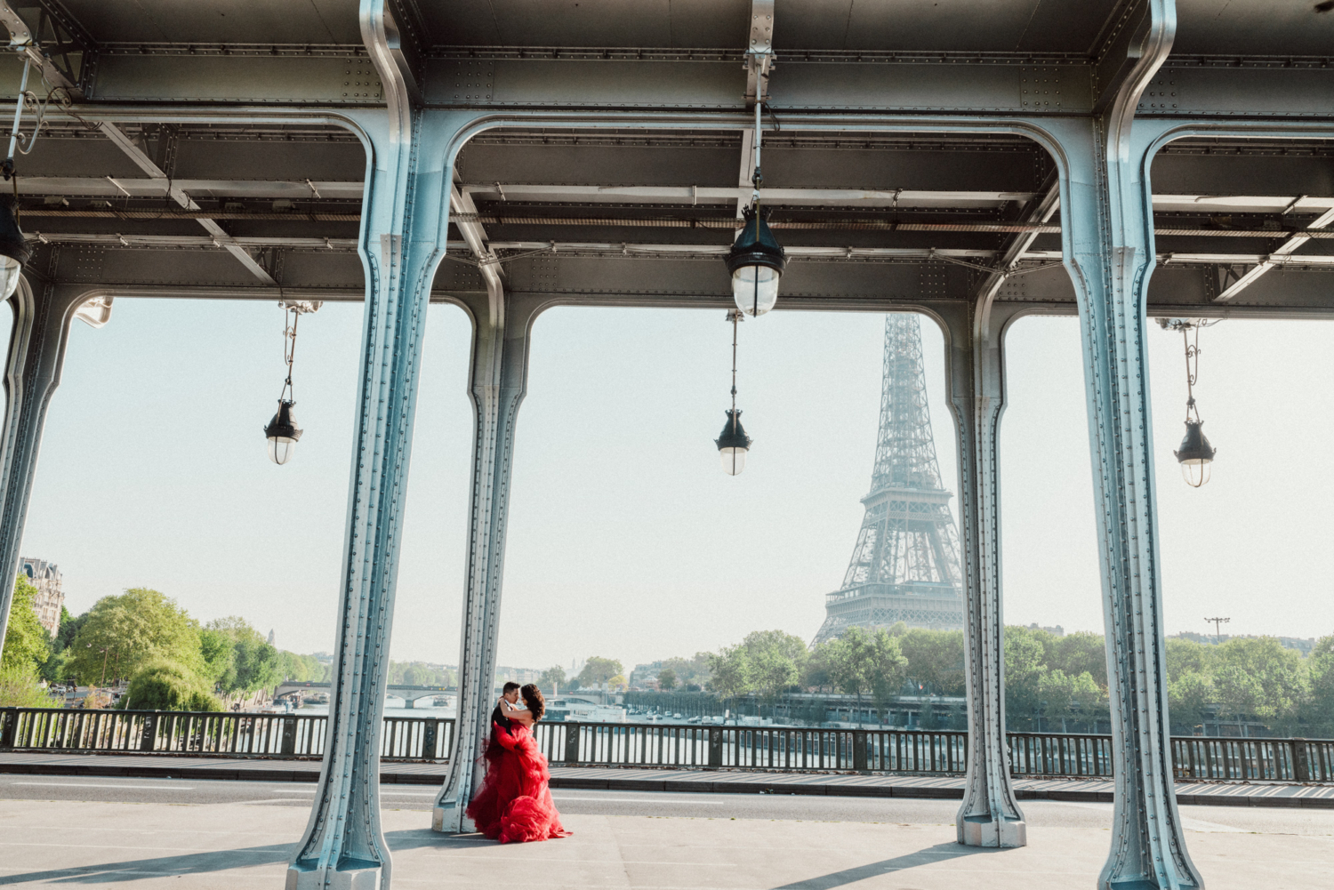 asian couple embrace in paris with view of eiffel tower