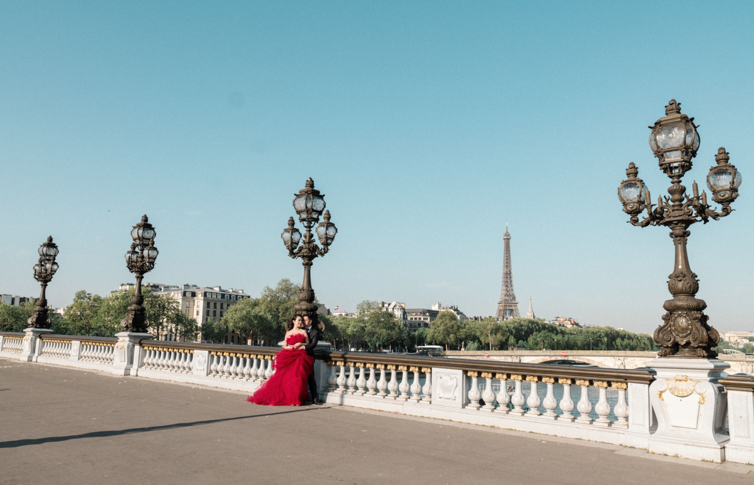 asian couple embrace on pont alexandre bridge in paris
