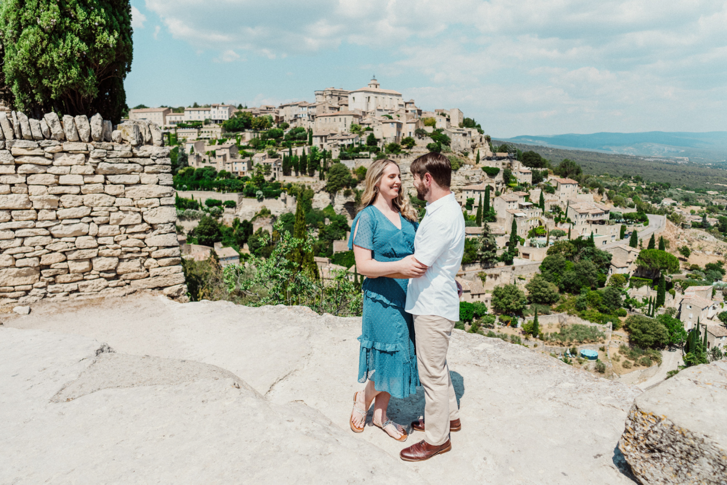 couple embrace with view of gordes village